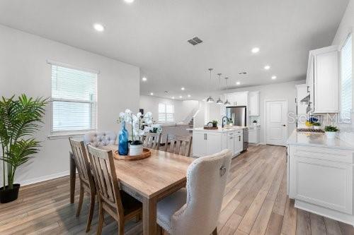 dining room with hardwood / wood-style floors, a wealth of natural light, and sink