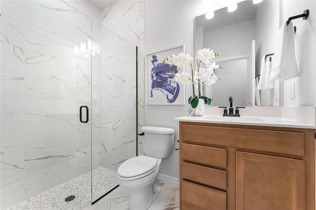 bathroom featuring vanity, a shower with shower door, and toilet