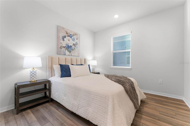 bedroom with dark hardwood / wood-style flooring