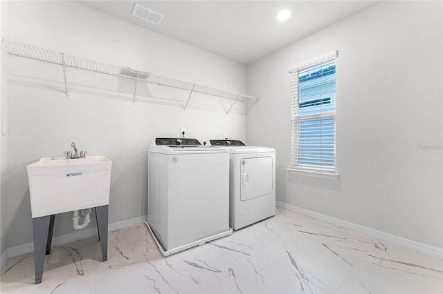 laundry area with washing machine and clothes dryer