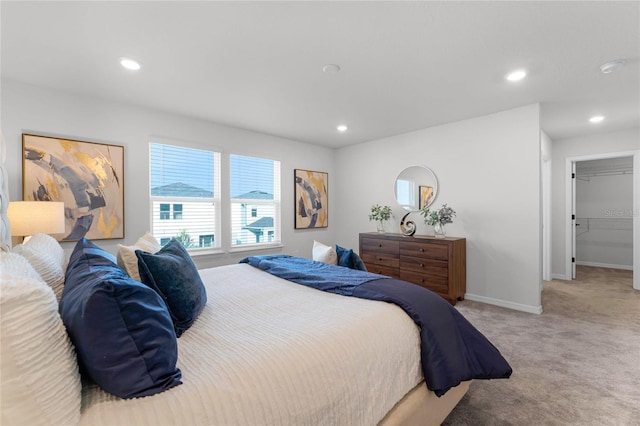 bedroom featuring carpet, a spacious closet, and a closet