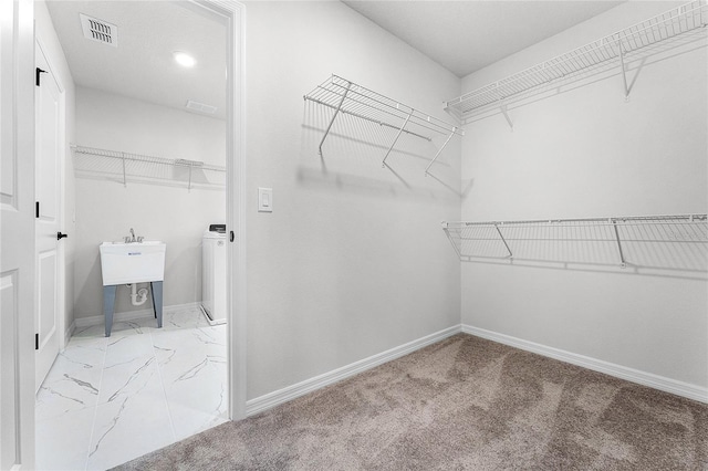 walk in closet featuring washer / dryer