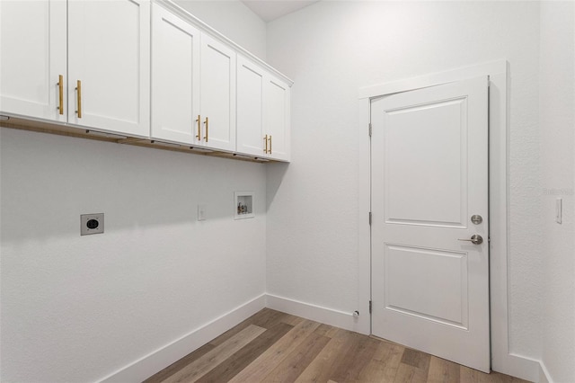 laundry area featuring cabinets, electric dryer hookup, washer hookup, and light wood-type flooring