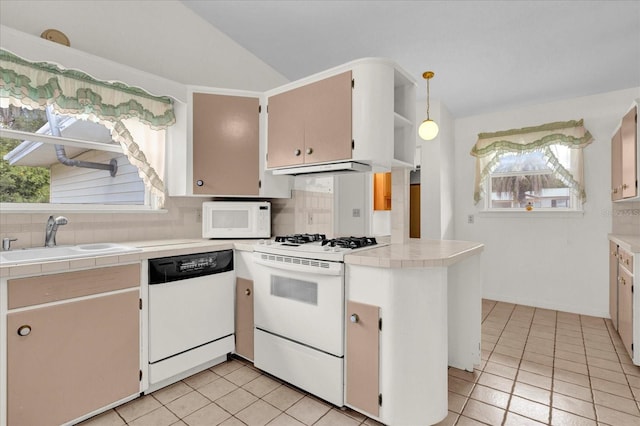 kitchen featuring tasteful backsplash, tile countertops, sink, and white appliances