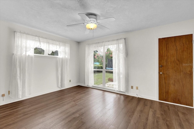 unfurnished room featuring ceiling fan, dark hardwood / wood-style floors, and a textured ceiling