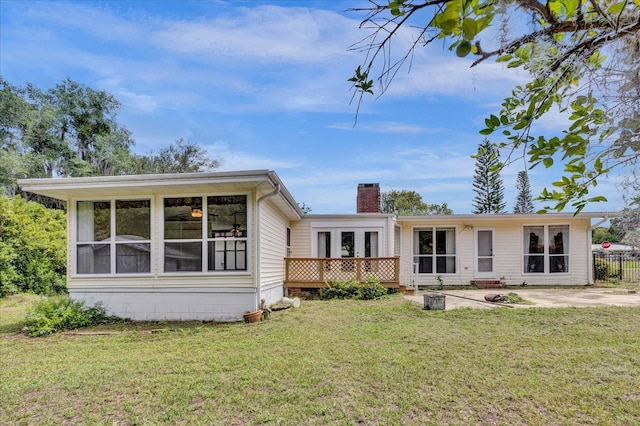 view of front of home with a front lawn, a patio area, and a wooden deck