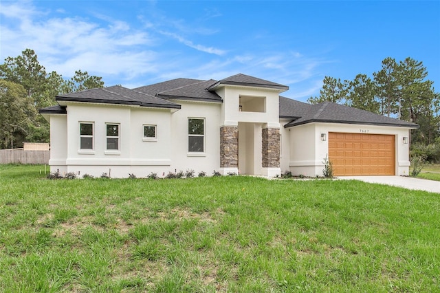 prairie-style home featuring a garage and a front lawn