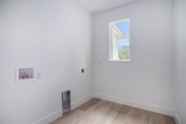 clothes washing area with light hardwood / wood-style flooring, hookup for an electric dryer, and washer hookup