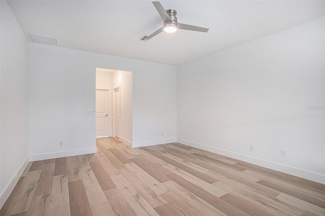 spare room featuring light wood-type flooring and ceiling fan