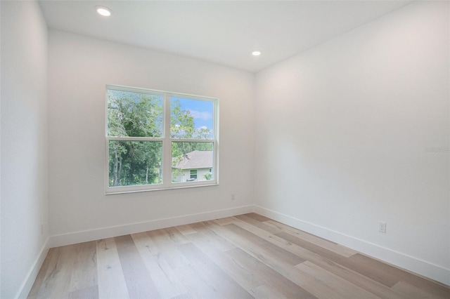 spare room featuring light hardwood / wood-style floors and a wealth of natural light