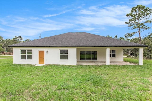 back of house with a patio area and a lawn