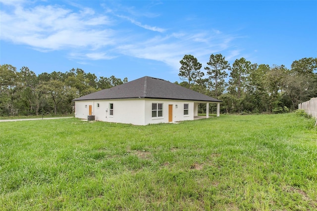 back of house with a yard and cooling unit