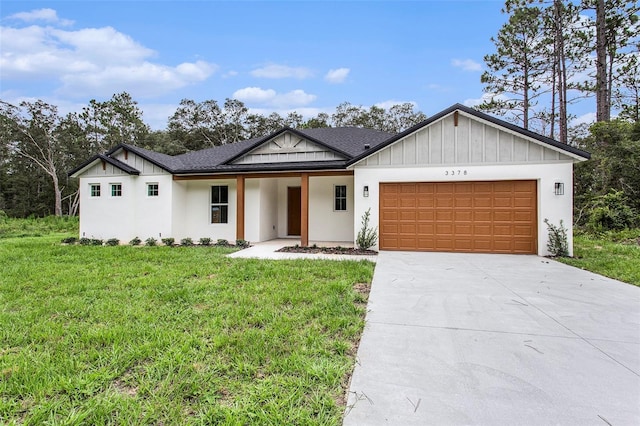 view of front of property with a garage and a front lawn