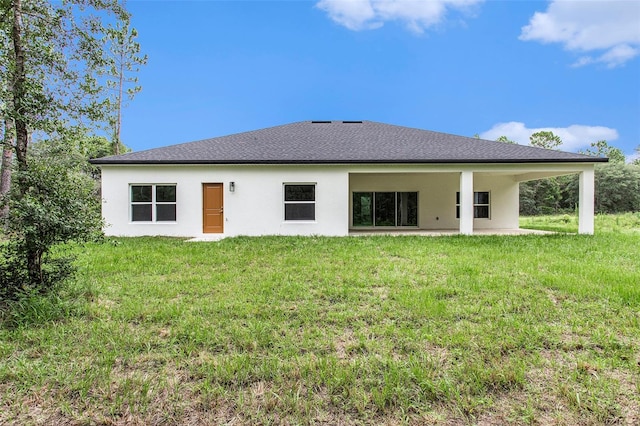 back of house featuring a yard