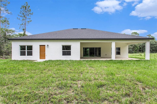 rear view of house with a patio and a yard