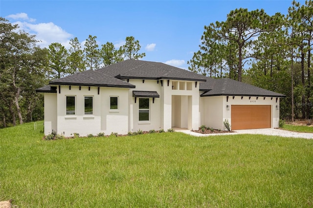 prairie-style home with a garage and a front lawn