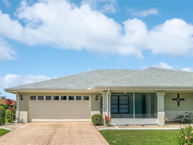 view of front facade with a garage and a front lawn