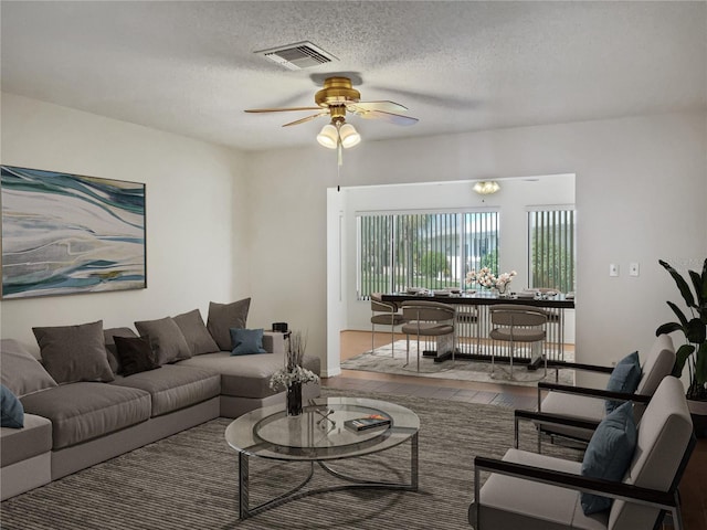 living room with wood-type flooring, a textured ceiling, and ceiling fan