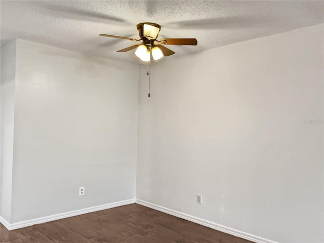 spare room featuring a textured ceiling, ceiling fan, and dark wood-type flooring