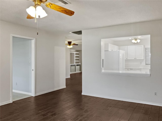 unfurnished room featuring ceiling fan and dark wood-type flooring