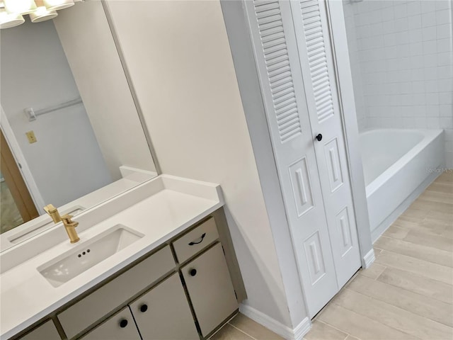 bathroom featuring vanity and tiled shower / bath