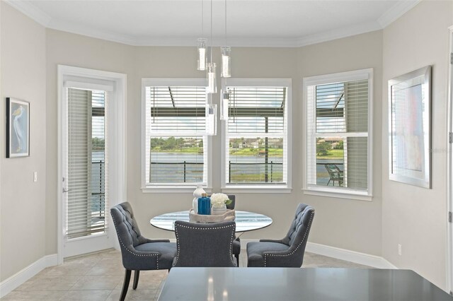 dining space with crown molding and light tile patterned floors