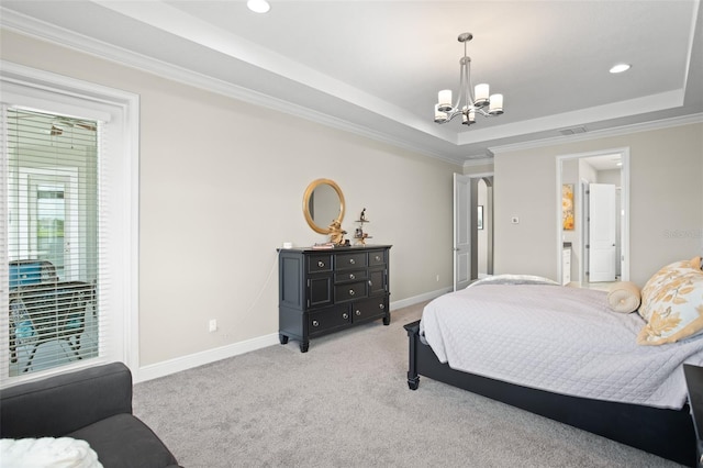 carpeted bedroom with a tray ceiling, a chandelier, and ornamental molding