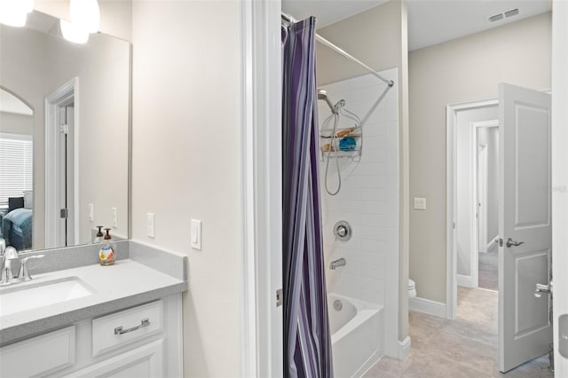 full bathroom with tile patterned floors, vanity, toilet, and shower / bath combo with shower curtain