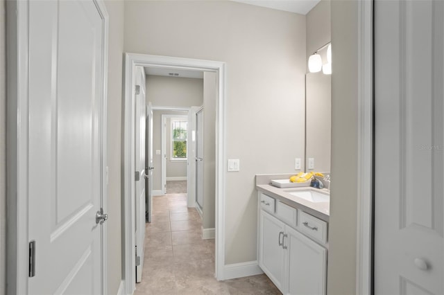 bathroom featuring tile patterned flooring and vanity