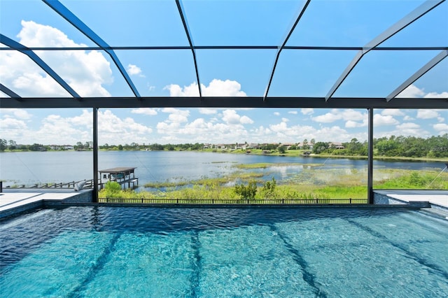 view of swimming pool with a water view and glass enclosure