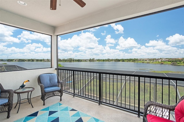 balcony featuring a water view and ceiling fan