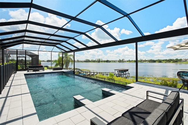 view of pool featuring a lanai, a patio area, and a water view