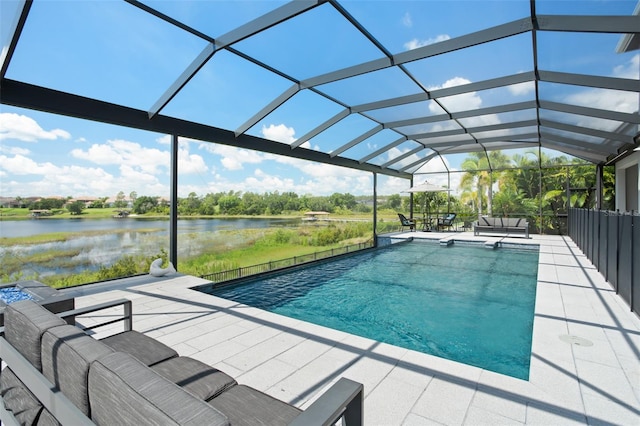 view of swimming pool with a lanai, a patio area, and a water view