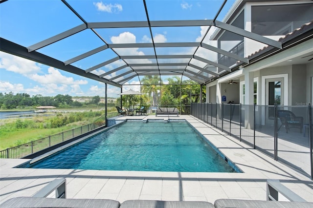 view of swimming pool featuring a patio, ceiling fan, and a lanai