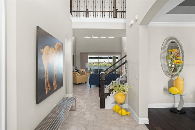 foyer featuring a high ceiling and ornamental molding