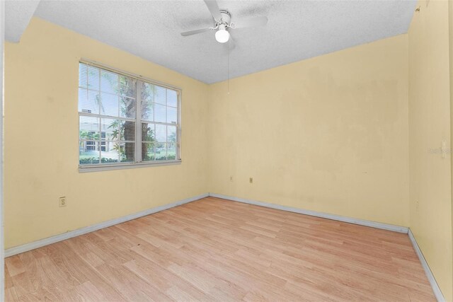 spare room featuring ceiling fan, a textured ceiling, and light wood-type flooring