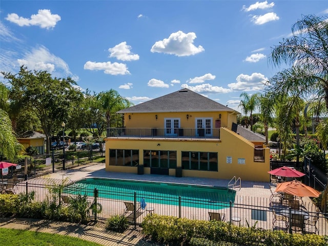 view of swimming pool with a patio and french doors