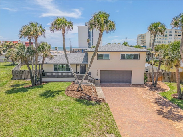 view of front of house featuring a front yard and a garage