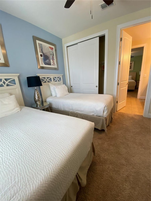 bedroom featuring carpet flooring, ceiling fan, and a closet