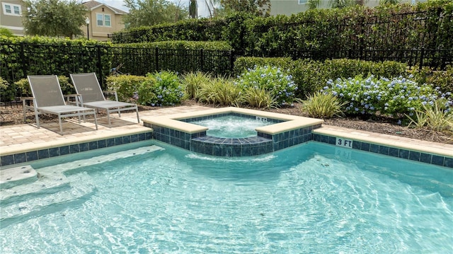 view of swimming pool featuring an in ground hot tub and a patio