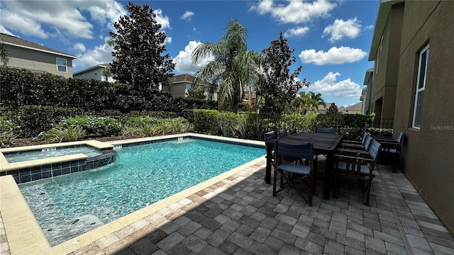 view of pool featuring an in ground hot tub and a patio