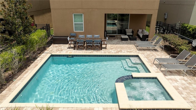 view of swimming pool with an in ground hot tub, an outdoor hangout area, and a patio area