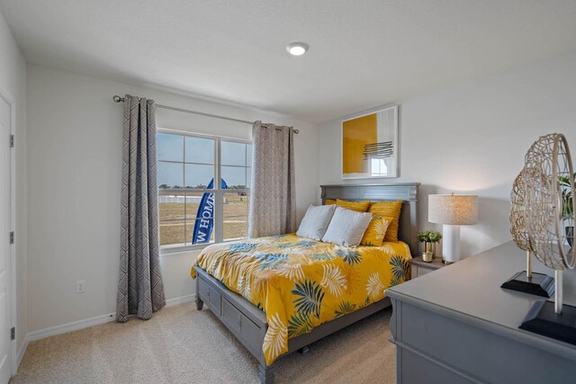 bedroom featuring light colored carpet