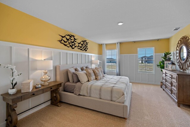 bedroom with light colored carpet