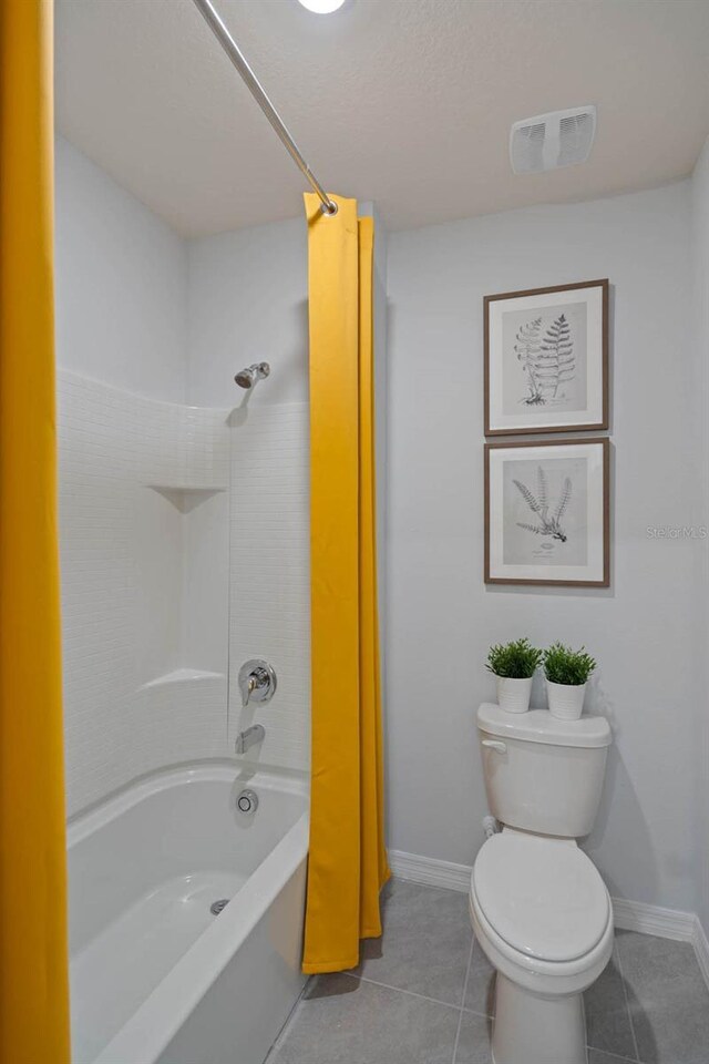 bathroom featuring tile patterned flooring, toilet, and shower / bathtub combination with curtain