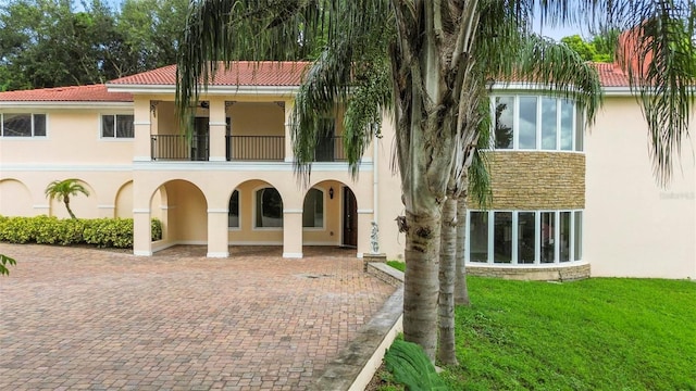 exterior space with a balcony and a yard