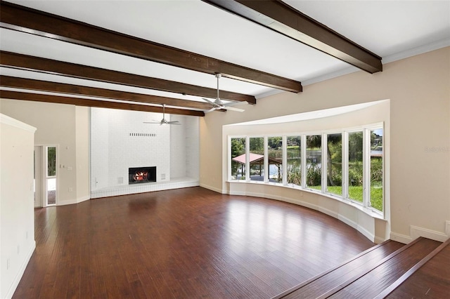 unfurnished living room featuring hardwood / wood-style flooring, beamed ceiling, a brick fireplace, and ceiling fan