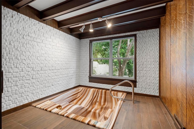 misc room featuring hardwood / wood-style floors and beamed ceiling