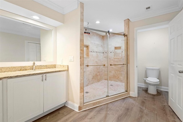 bathroom featuring crown molding, hardwood / wood-style floors, toilet, and walk in shower