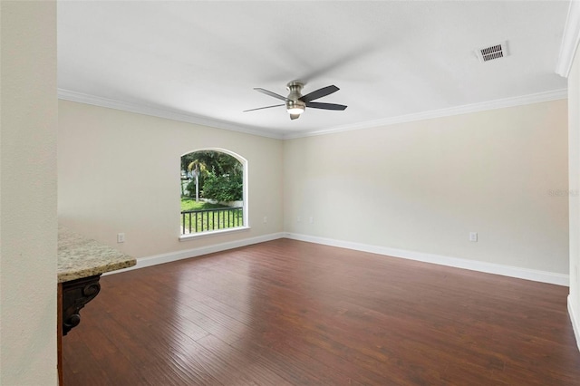 unfurnished room featuring ceiling fan, dark hardwood / wood-style floors, and ornamental molding